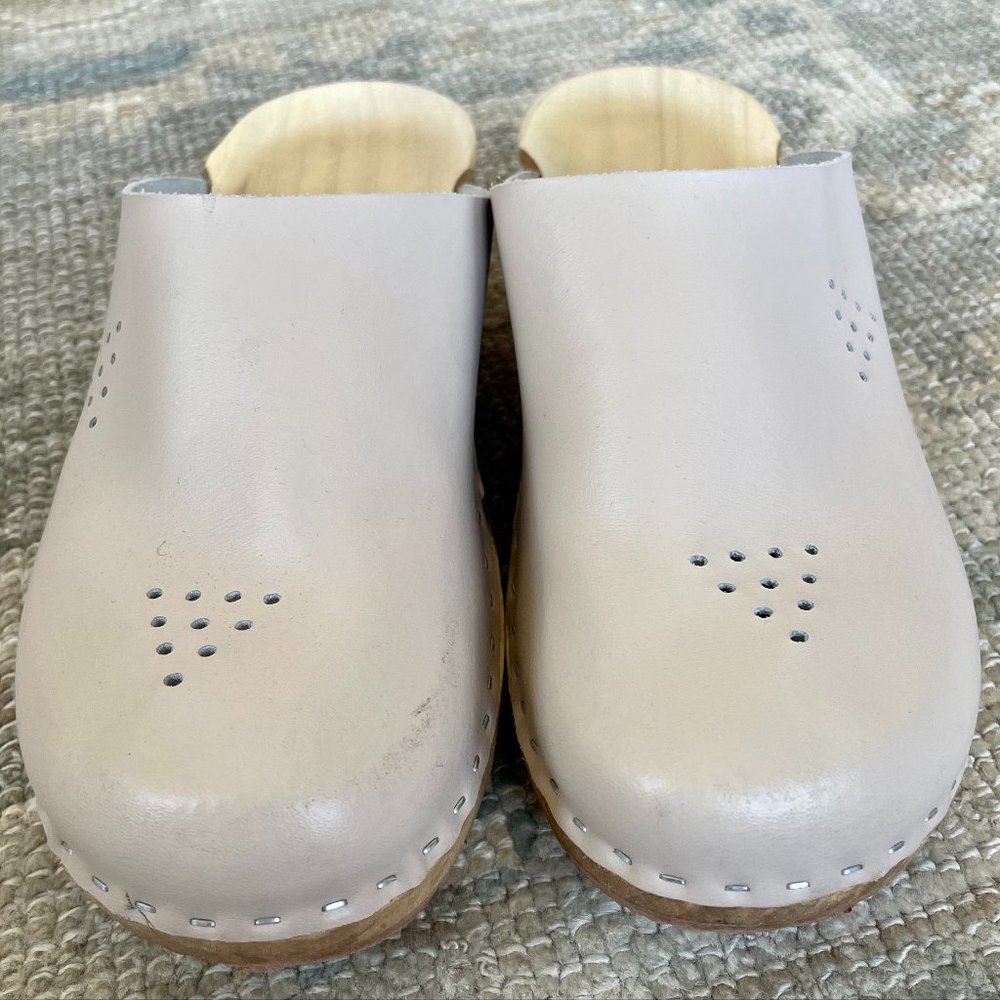 Wooden clogs. Wooden sole and leather upper.